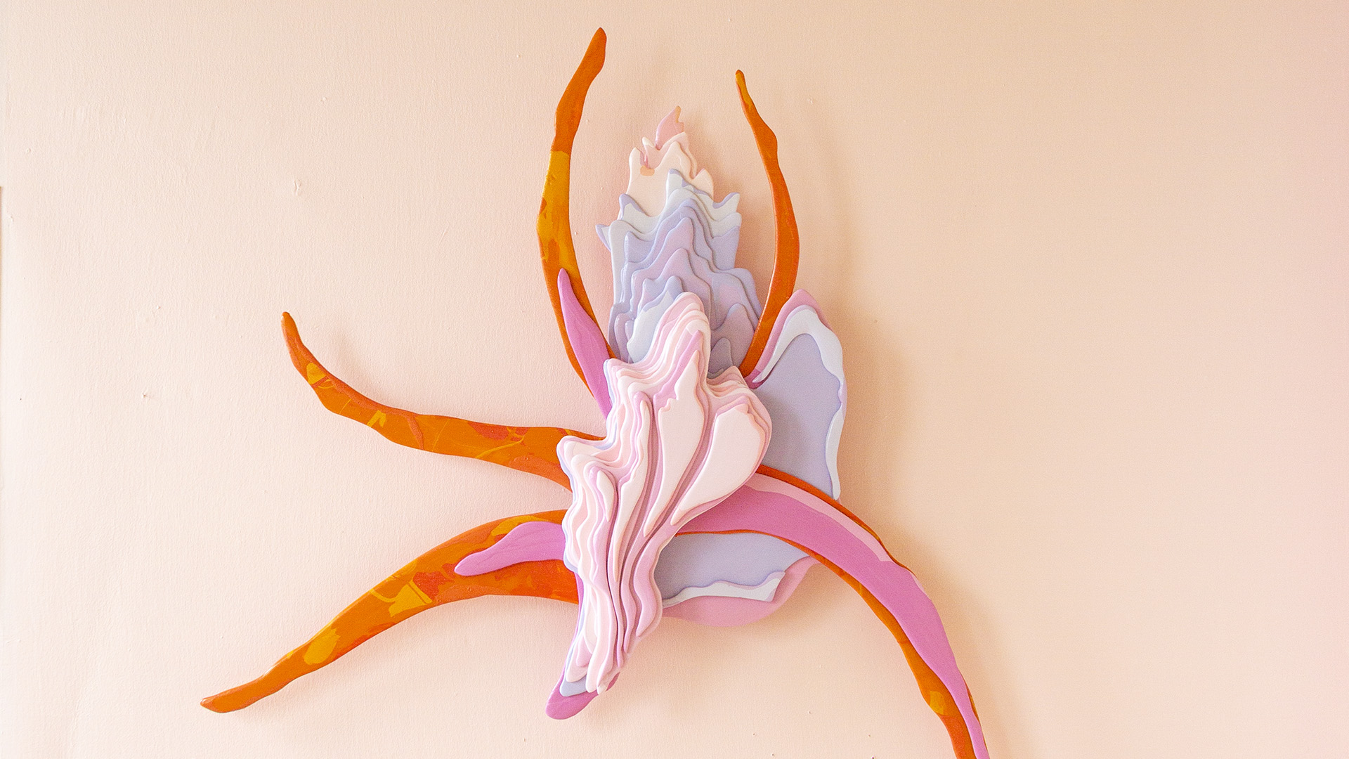 A brightly coloured sculpture reminiscent of an orchid.